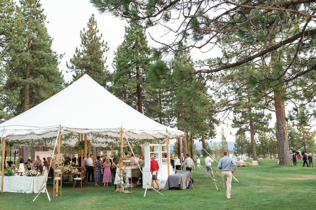 Wedding party and guests under a canopy at Edgewood Tahoe wedding