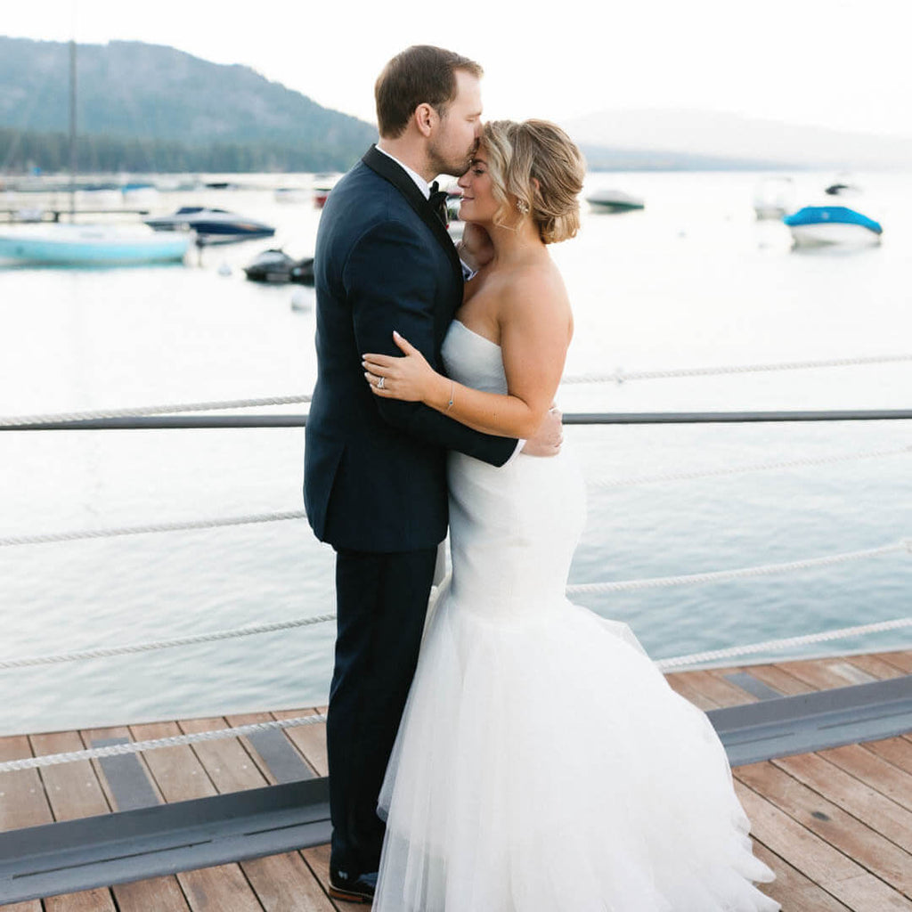 Bride and groom on a dock in Lake Tahoe