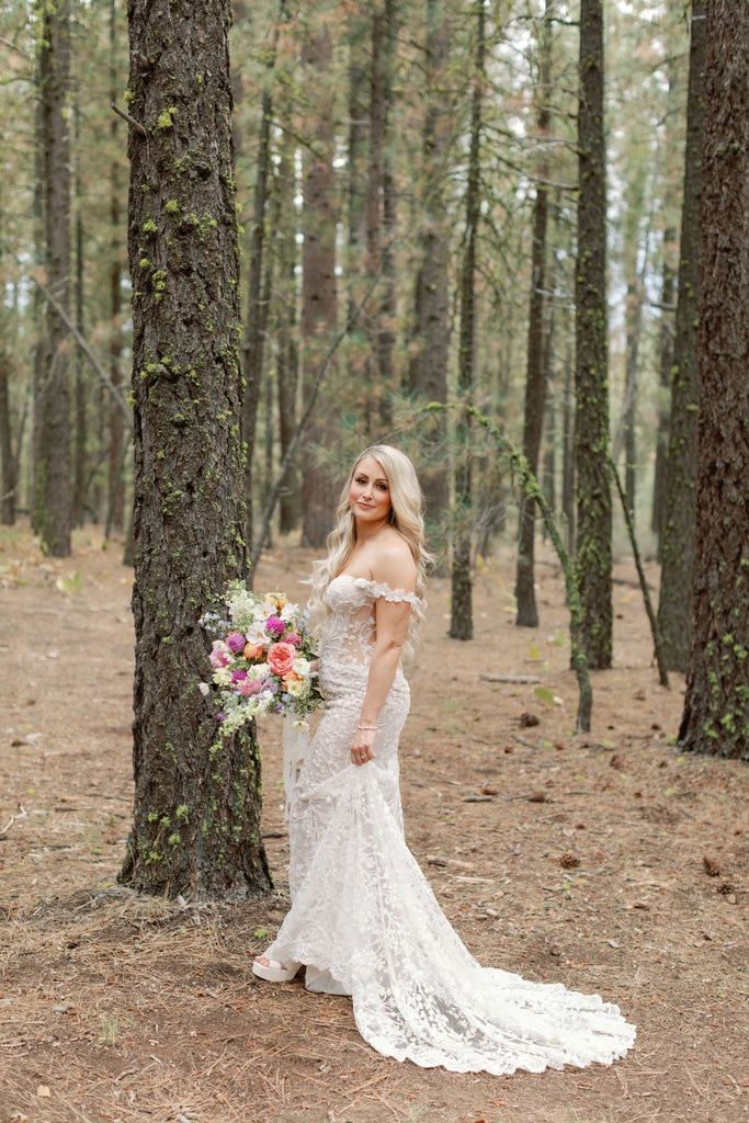 Bride standing in the trees in Lake Tahoe on her wedding day